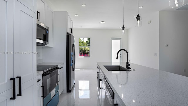 1351 Sulstone Dr, Punta Gorda, FL 33983 - kitchen featuring appliances with stainless steel finishes, a sink, recessed lighting, light stone counters, and pendant lighting