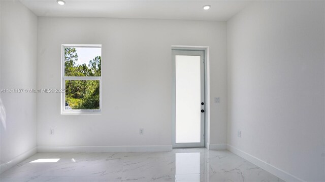 1351 Sulstone Dr, Punta Gorda, FL 33983 - empty room with plenty of natural light, marble finish floors, baseboards, and recessed lighting