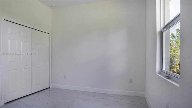 1351 Sulstone Dr, Punta Gorda, FL 33983 - unfurnished bedroom with marble finish floors, baseboards, and a closet