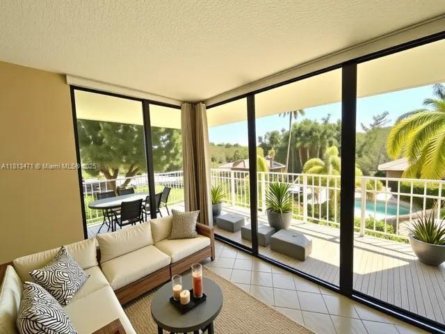 1000 Quayside Te Unit 410, Miami, FL 33138 - living room featuring expansive windows, light tile patterned floors, and a textured ceiling