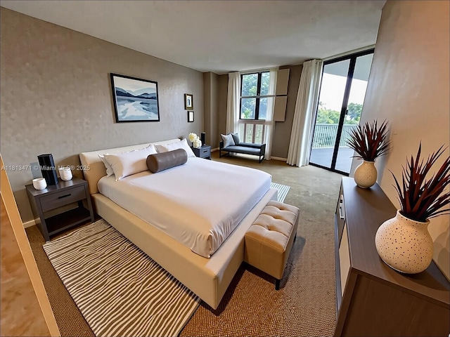 1000 Quayside Te Unit 410, Miami, FL 33138 - carpeted bedroom featuring access to outside, baseboards, and a wall of windows
