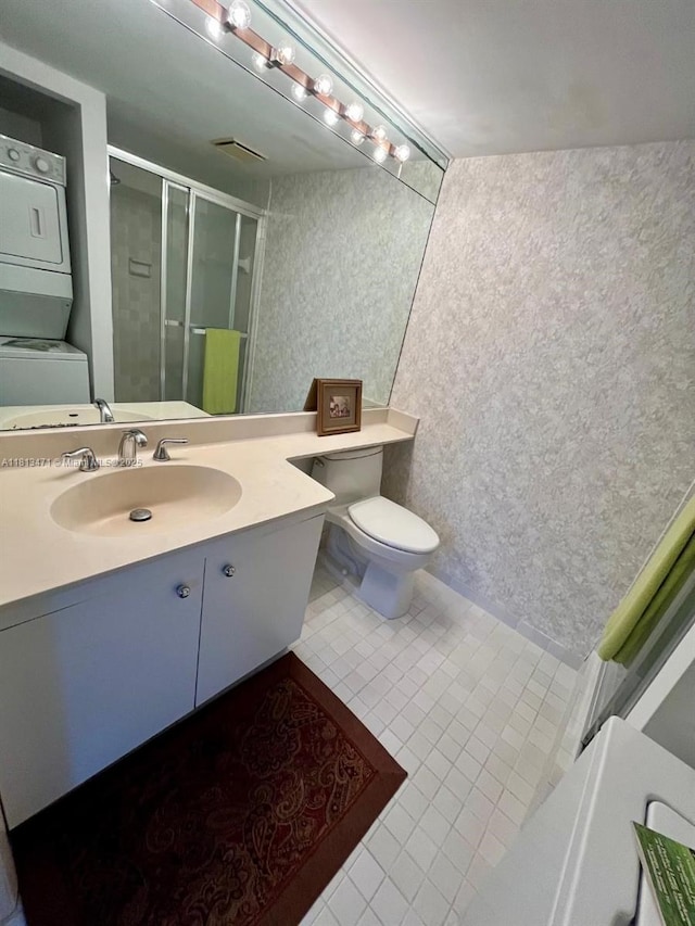1000 Quayside Te Unit 410, Miami, FL 33138 - full bath with estacked washer and dryer, toilet, a shower stall, and tile patterned flooring