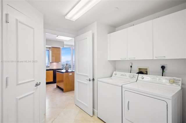 781 Crandon Blvd Unit 1802, Key Biscayne, FL 33149 - washroom with cabinet space, washer and clothes dryer, and light tile patterned floors