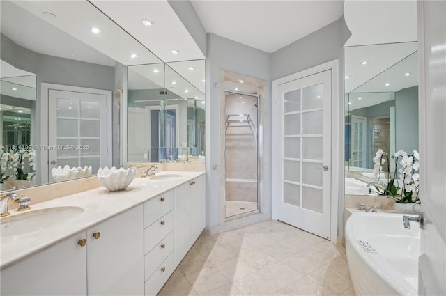 781 Crandon Blvd Unit 1802, Key Biscayne, FL 33149 - full bathroom with double vanity, a garden tub, a shower stall, french doors, and recessed lighting