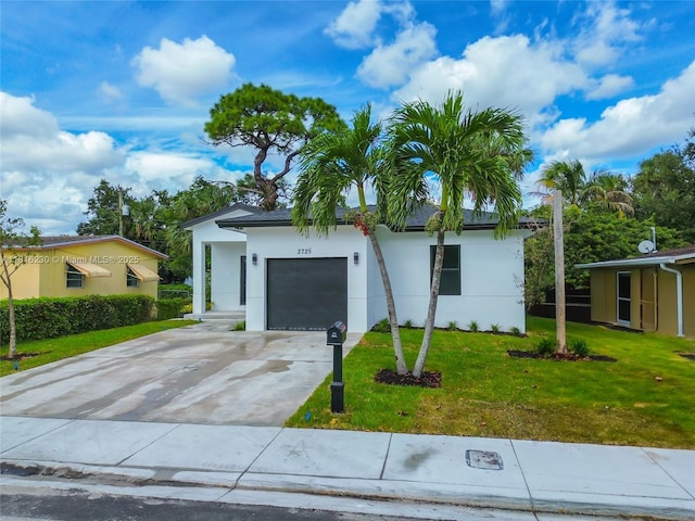 2725 NW 7th St, Fort Lauderdale, FL 33311 - view of front of house featuring stucco siding, an attached garage, concrete driveway, and a front lawn