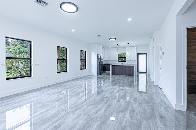 2725 NW 7th St, Fort Lauderdale, FL 33311 - unfurnished living room featuring plenty of natural light, baseboards, and recessed lighting