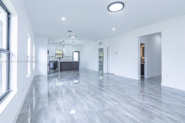 2725 NW 7th St, Fort Lauderdale, FL 33311 - unfurnished living room with baseboards and recessed lighting