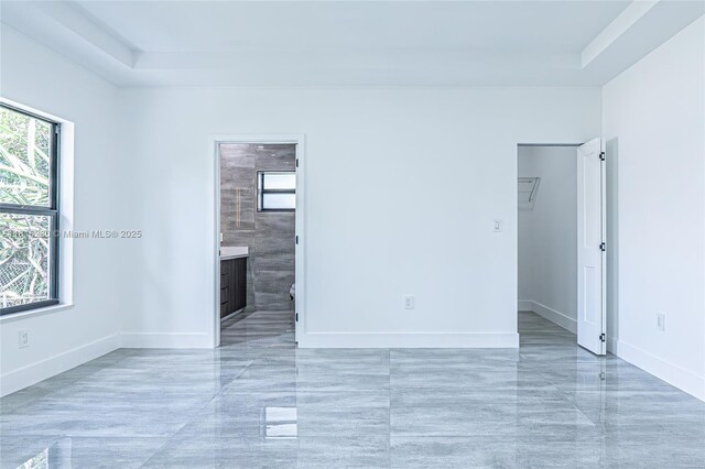 2725 NW 7th St, Fort Lauderdale, FL 33311 - empty room with plenty of natural light, a raised ceiling, and baseboards