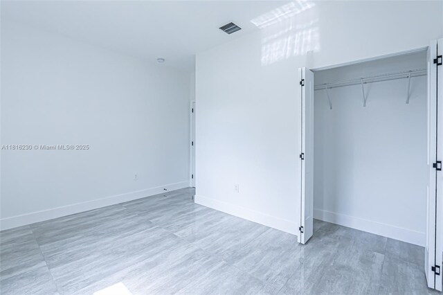 2725 NW 7th St, Fort Lauderdale, FL 33311 - unfurnished bedroom with baseboards and a closet