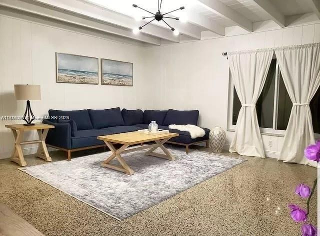 482 NE 8th Ave, Deerfield Beach, FL 33441 - living room featuring a chandelier, beamed ceiling, and speckle patterned floor