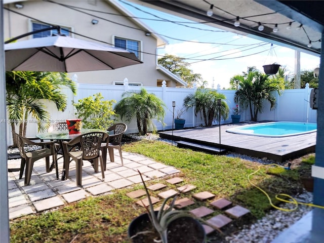 482 NE 8th Ave, Deerfield Beach, FL 33441 - fenced backyard featuring a wooden deck, a patio area, and outdoor dining area