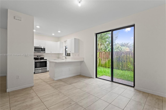6496 S Anise Ct, Davie, FL 33314 - kitchen with stainless steel appliances, light countertops, baseboards, and recessed lighting