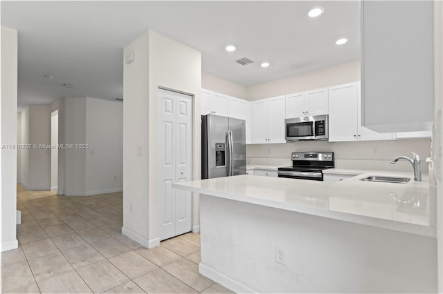6496 S Anise Ct, Davie, FL 33314 - kitchen featuring stainless steel appliances, a sink, light countertops, white cabinets, and light tile patterned flooring