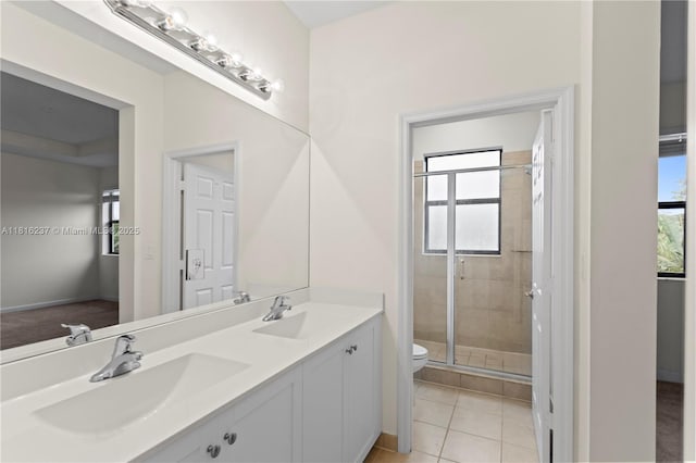 6496 S Anise Ct, Davie, FL 33314 - bathroom featuring toilet, a stall shower, double vanity, and plenty of natural light