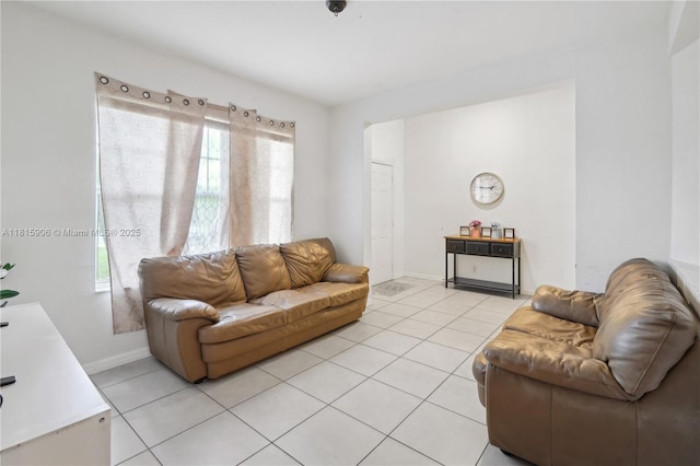 4441 SW Savona Blvd, Port St Lucie, FL 34953 - living area with plenty of natural light, light tile patterned floors, and baseboards