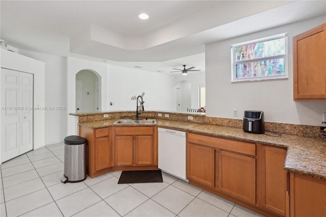 4441 SW Savona Blvd, Port St Lucie, FL 34953 - kitchen with a sink, dishwasher, brown cabinetry, and arched walkways