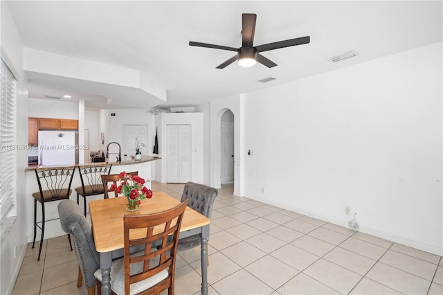 4441 SW Savona Blvd, Port St Lucie, FL 34953 - dining area featuring ceiling fan, arched walkways, and light tile patterned flooring