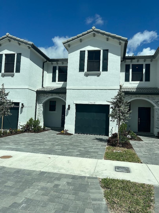 13019 SW 286th Way, Homestead, FL 33033 - mediterranean / spanish-style home featuring a tile roof, an attached garage, decorative driveway, and stucco siding