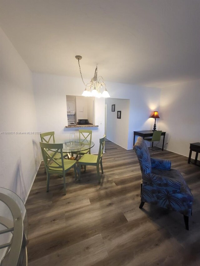 600 Layne Blvd Unit 118, Hallandale Beach, FL 33009 - dining space featuring wood finished floors and a chandelier