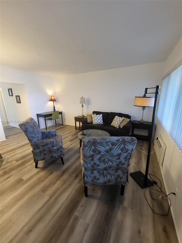 600 Layne Blvd Unit 118, Hallandale Beach, FL 33009 - living area featuring wood finished floors, an AC wall unit, and baseboards