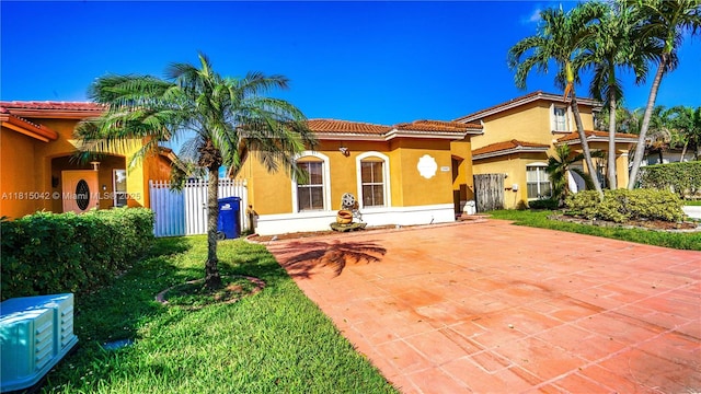 7997 NW 199th Ter, Hialeah, FL 33015 - mediterranean / spanish house featuring stucco siding, a tiled roof, and driveway
