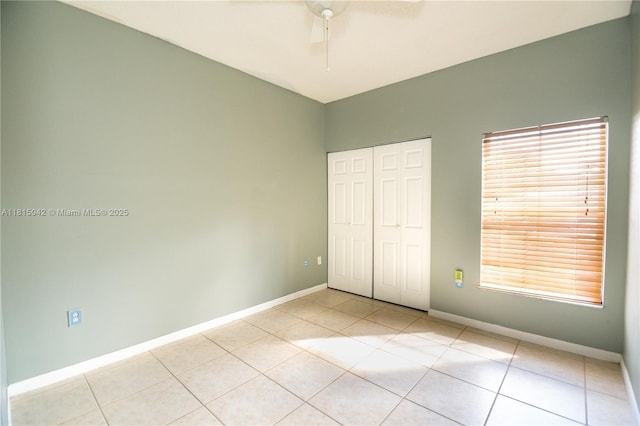 7997 NW 199th Ter, Hialeah, FL 33015 - unfurnished bedroom with light tile patterned flooring, a closet, ceiling fan, and multiple windows