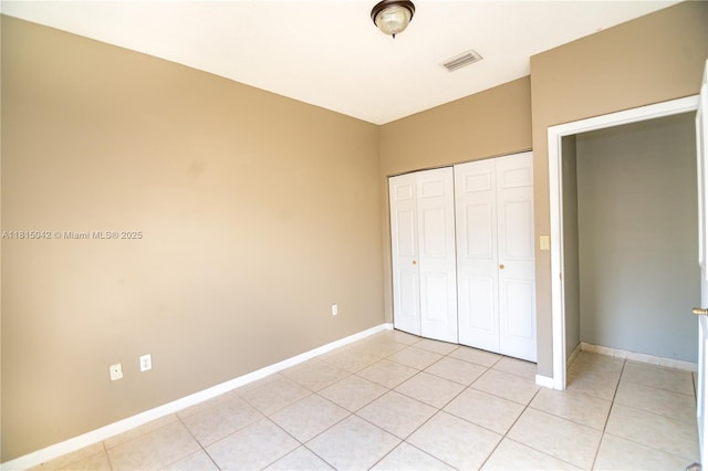 7997 NW 199th Ter, Hialeah, FL 33015 - unfurnished bedroom with light tile patterned floors and a closet