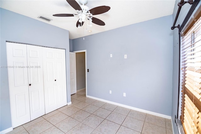 7997 NW 199th Ter, Hialeah, FL 33015 - unfurnished bedroom featuring a closet, light tile patterned floors, and a ceiling fan
