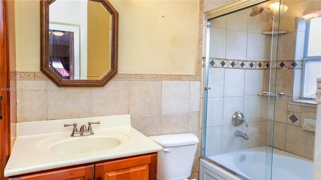 7997 NW 199th Ter, Hialeah, FL 33015 - bathroom featuring tile walls, vanity, shower / bath combination with glass door, and wainscoting