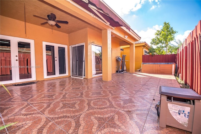 7997 NW 199th Ter, Hialeah, FL 33015 - fenced backyard with french doors, a hot tub, a patio, and a ceiling fan