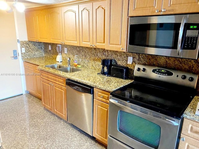 19201 Collins Ave Unit 441, Sunny Isles Beach, FL 33160 - kitchen featuring stainless steel appliances, a sink, tasteful backsplash, and light stone counters