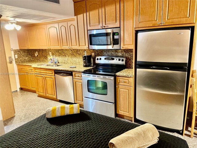 19201 Collins Ave Unit 441, Sunny Isles Beach, FL 33160 - kitchen with stainless steel appliances, backsplash, a sink, and light stone countertops