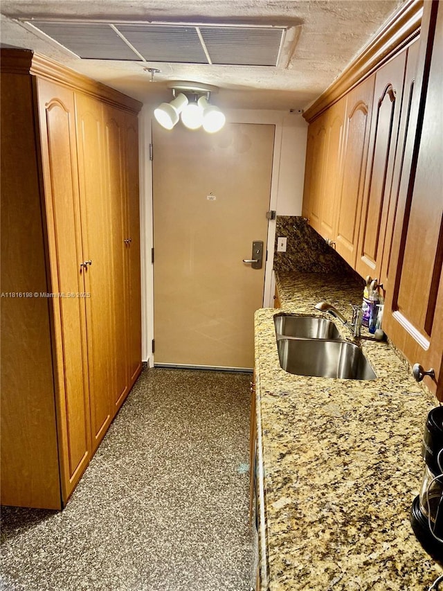 19201 Collins Ave Unit 441, Sunny Isles Beach, FL 33160 - kitchen with a sink, light stone countertops, and baseboards