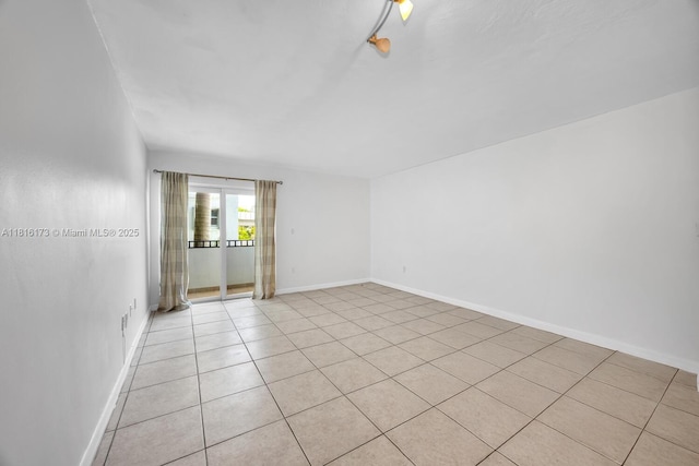 2465 SW 18th Ave Unit 3210, Miami, FL 33145 - empty room with light tile patterned floors and baseboards