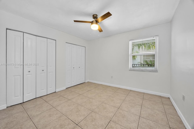 2465 SW 18th Ave Unit 3210, Miami, FL 33145 - unfurnished bedroom with multiple closets, baseboards, and light tile patterned flooring