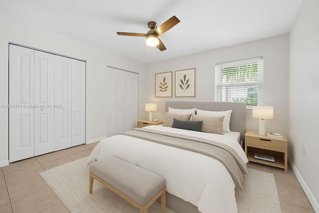 2465 SW 18th Ave Unit 3210, Miami, FL 33145 - bedroom featuring two closets, light tile patterned floors, ceiling fan, and baseboards