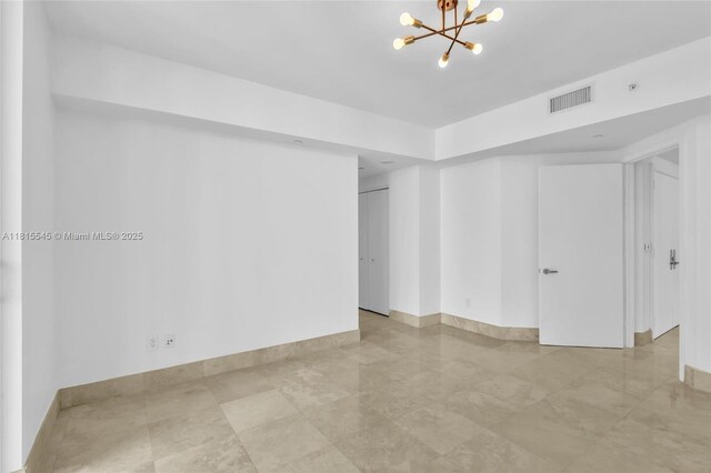 1331 Brickell Bay Dr Unit 1808, Miami, FL 33131 - empty room with a chandelier and baseboards