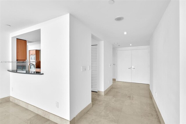 1331 Brickell Bay Dr Unit 1808, Miami, FL 33131 - corridor featuring baseboards, a sink, and recessed lighting