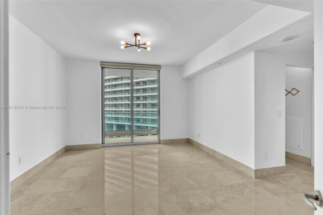 1331 Brickell Bay Dr Unit 1808, Miami, FL 33131 - empty room featuring a chandelier, tile patterned flooring, and floor to ceiling windows