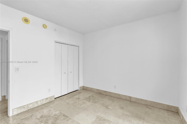 1331 Brickell Bay Dr Unit 1808, Miami, FL 33131 - unfurnished bedroom featuring baseboards and a closet