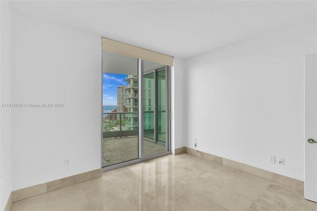 1331 Brickell Bay Dr Unit 1808, Miami, FL 33131 - tiled spare room with expansive windows, a water view, a city view, and baseboards