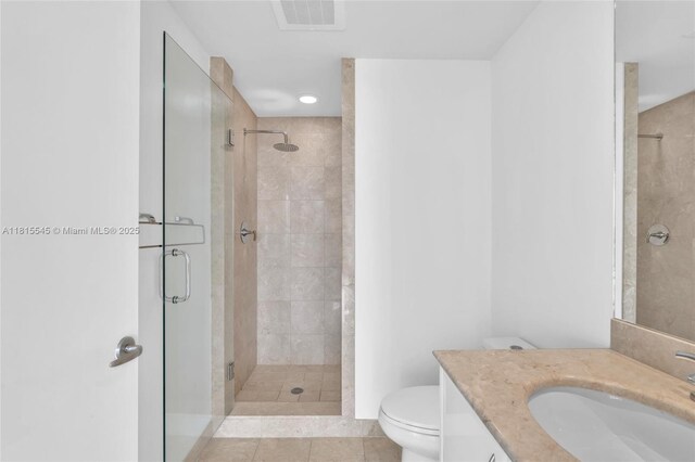 1331 Brickell Bay Dr Unit 1808, Miami, FL 33131 - bathroom featuring toilet, a stall shower, vanity, and tile patterned floors