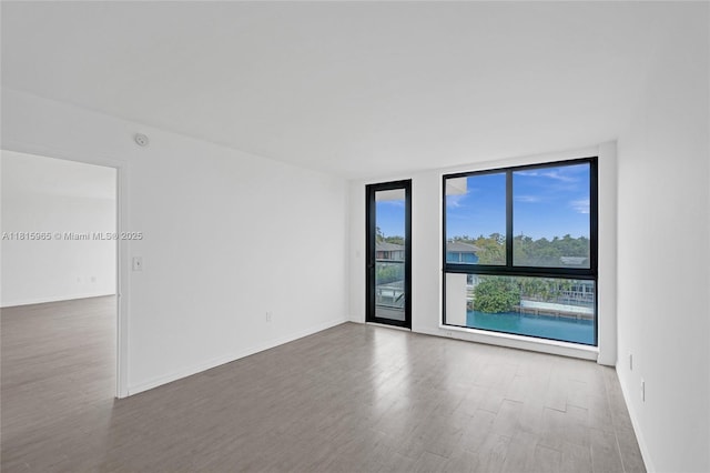 9800 W Bay Harbor Dr Unit 401, Bay Harbor Islands, FL 33154 - spare room with wood finished floors, baseboards, and a smoke detector