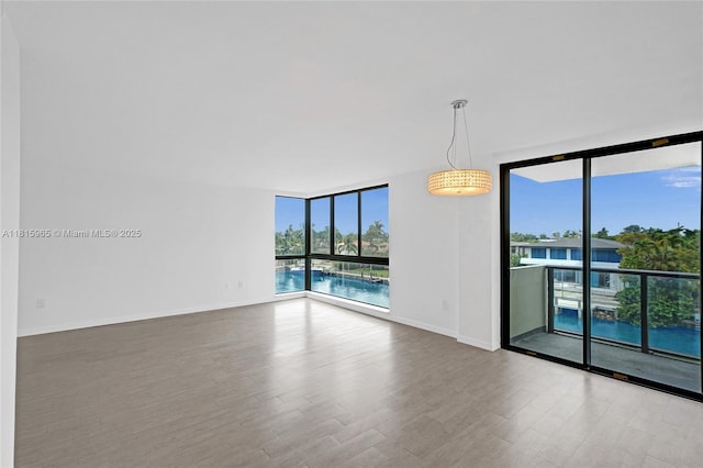 9800 W Bay Harbor Dr Unit 401, Bay Harbor Islands, FL 33154 - unfurnished room featuring expansive windows, wood finished floors, and baseboards