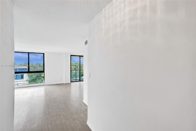 9800 W Bay Harbor Dr Unit 401, Bay Harbor Islands, FL 33154 - corridor featuring baseboards, wood finished floors, and a wall of windows