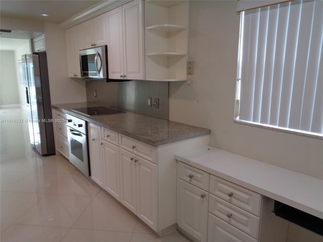 900 SW 125th Way Unit 112R, Pembroke Pines, FL 33027 - kitchen featuring appliances with stainless steel finishes, white cabinets, light tile patterned floors, and light countertops