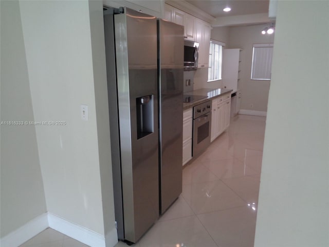 900 SW 125th Way Unit 112R, Pembroke Pines, FL 33027 - kitchen with stainless steel appliances, baseboards, white cabinetry, light tile patterned flooring, and recessed lighting