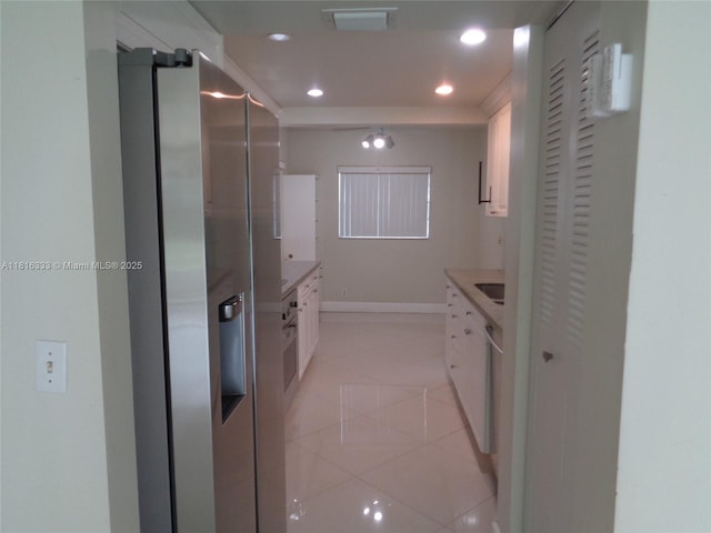 900 SW 125th Way Unit 112R, Pembroke Pines, FL 33027 - kitchen featuring stainless steel fridge, white cabinetry, recessed lighting, light tile patterned floors, and baseboards