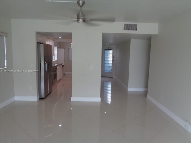 900 SW 125th Way Unit 112R, Pembroke Pines, FL 33027 - spare room featuring light tile patterned floors, a ceiling fan, and baseboards