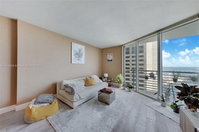 335 S Biscayne Blvd Unit 3110, Miami, FL 33131 - living room with expansive windows, wood finished floors, and a water view